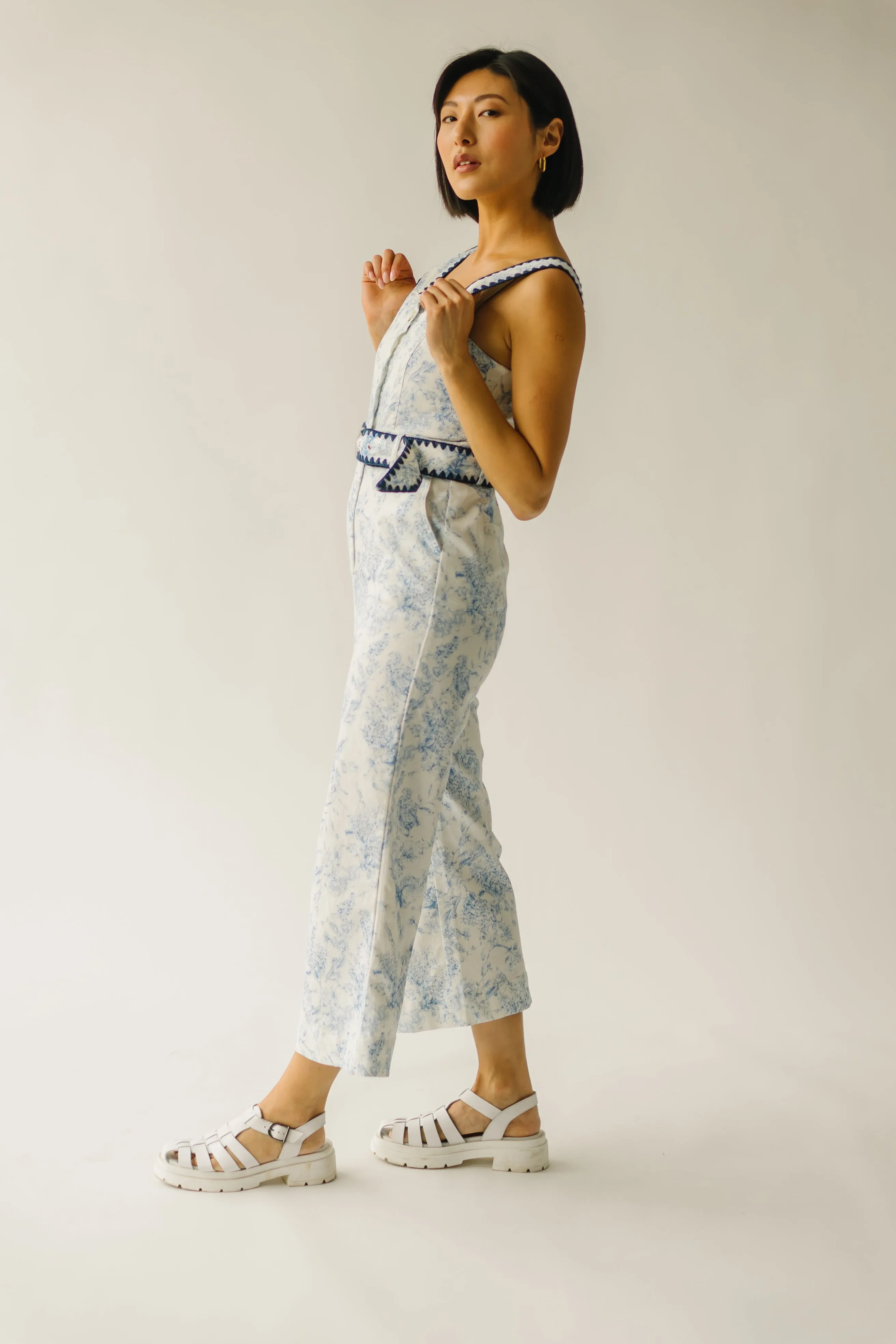 The Almada Belted Floral Jumpsuit in Ivory + Blue