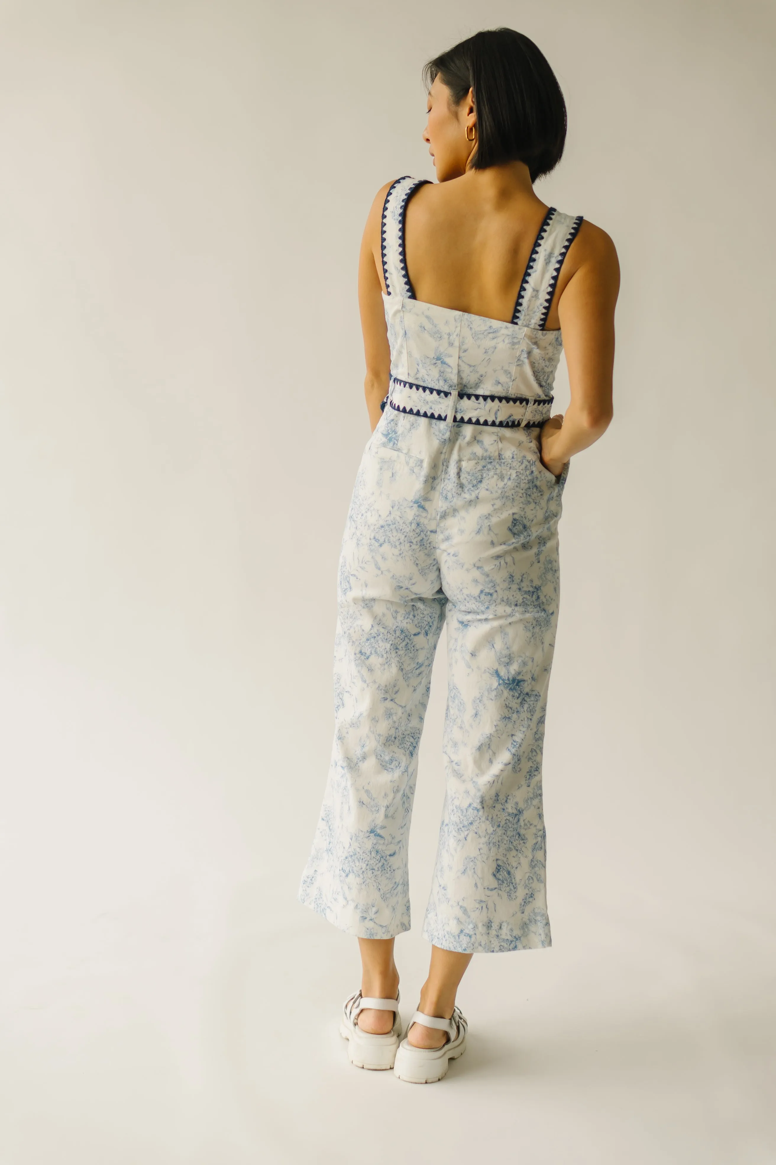 The Almada Belted Floral Jumpsuit in Ivory + Blue