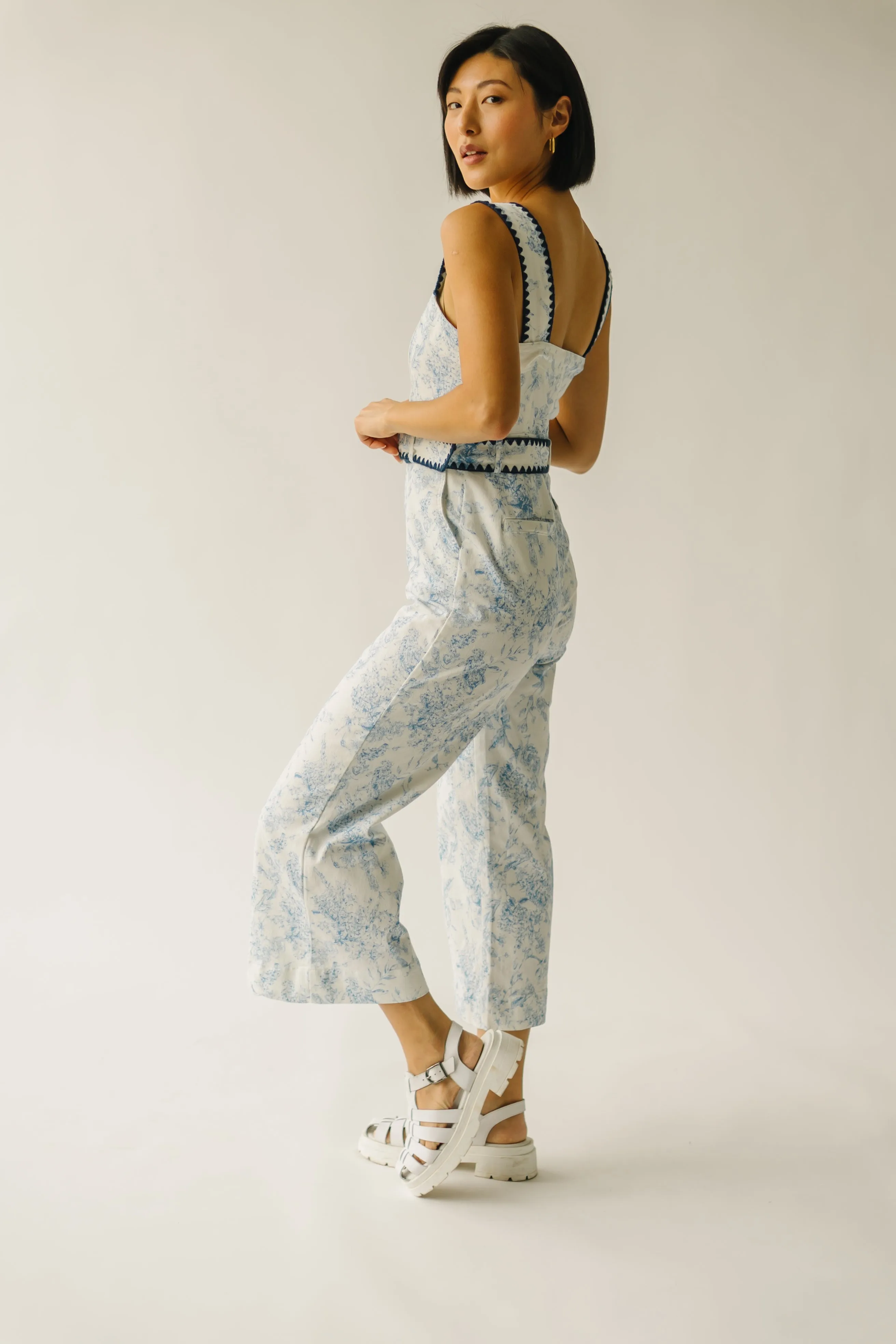 The Almada Belted Floral Jumpsuit in Ivory + Blue