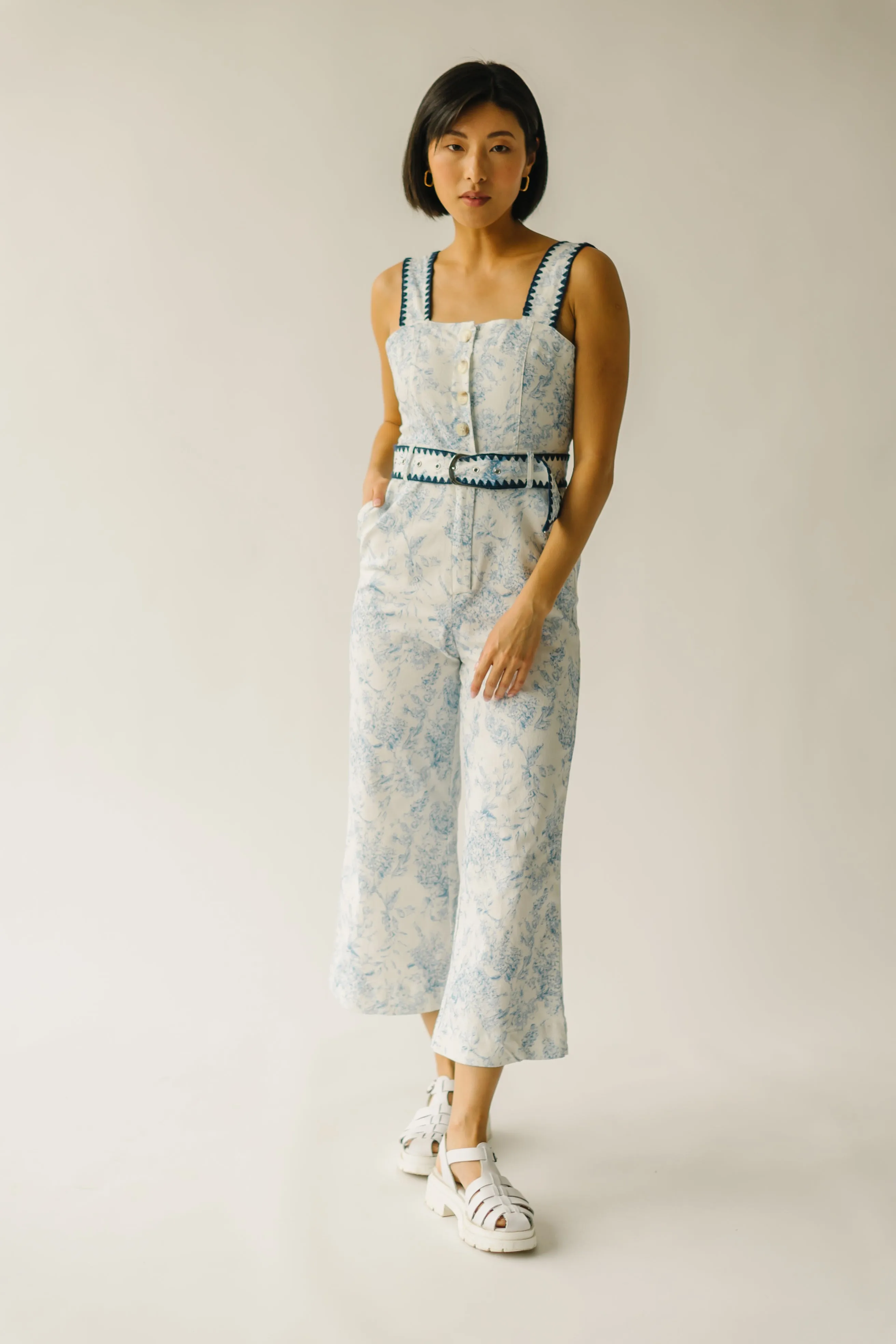 The Almada Belted Floral Jumpsuit in Ivory + Blue